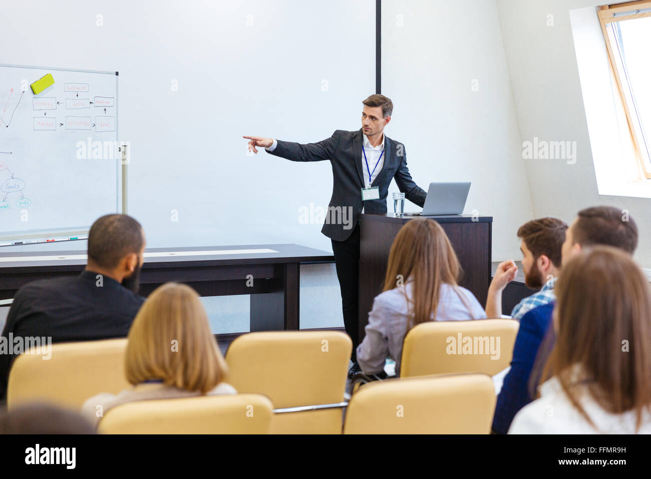 Speaker giving presentation at business conference in meeting hall Stock Photo
