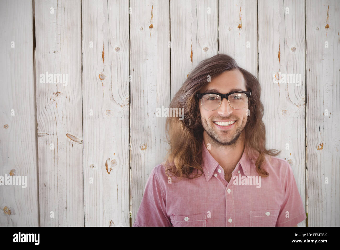 Composite image of happy hipster wearing eye glasses Stock Photo