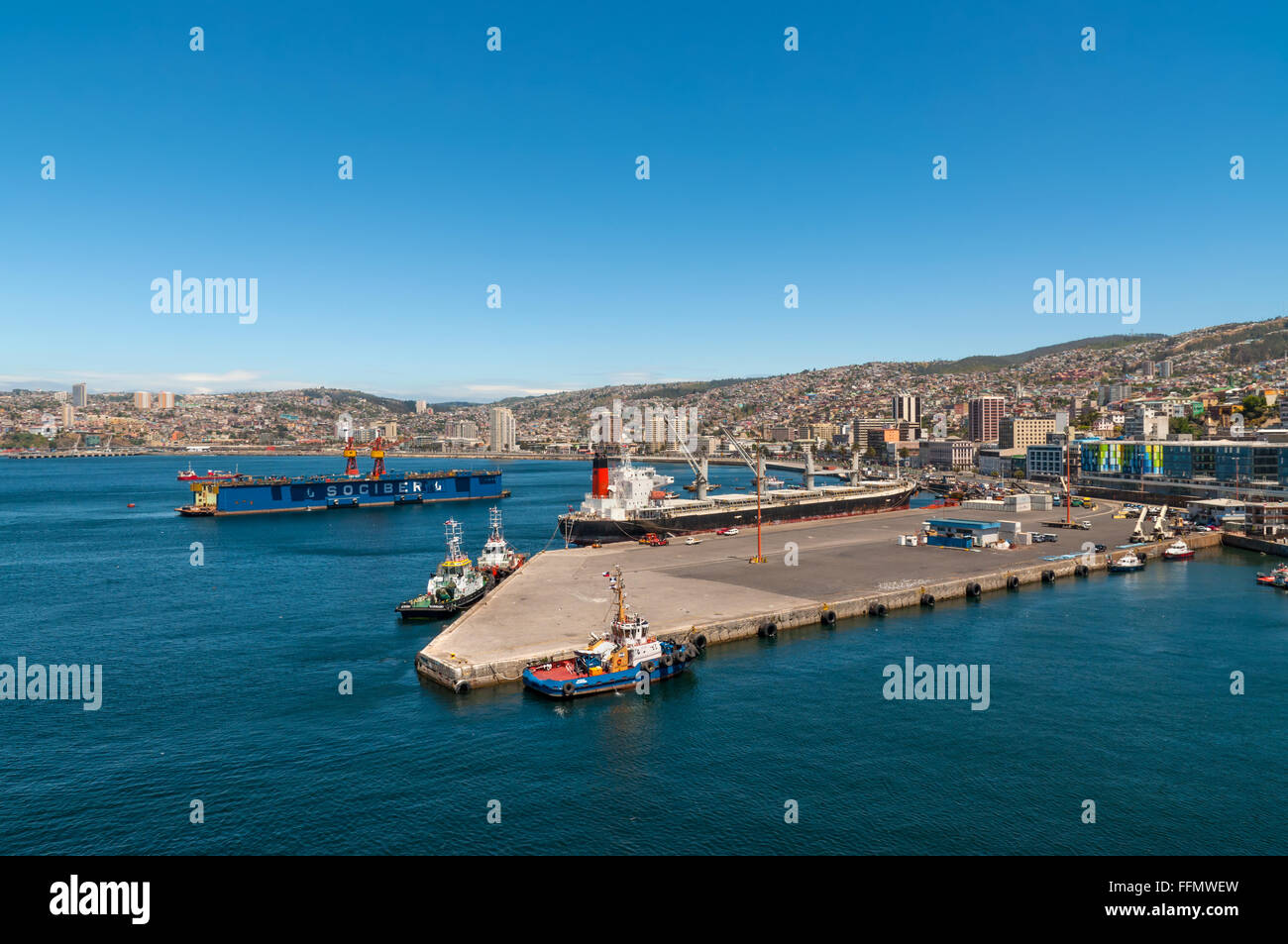 Panoramic view to the cargo sea port and residential area of Valparaiso city. Stock Photo