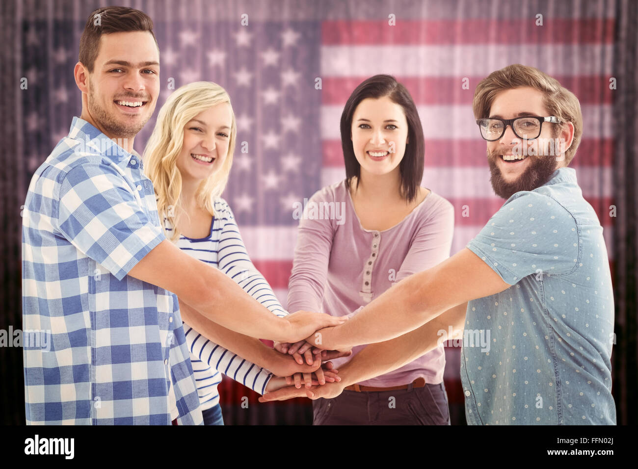 Composite image of portrait of smiling business people putting their hands together Stock Photo