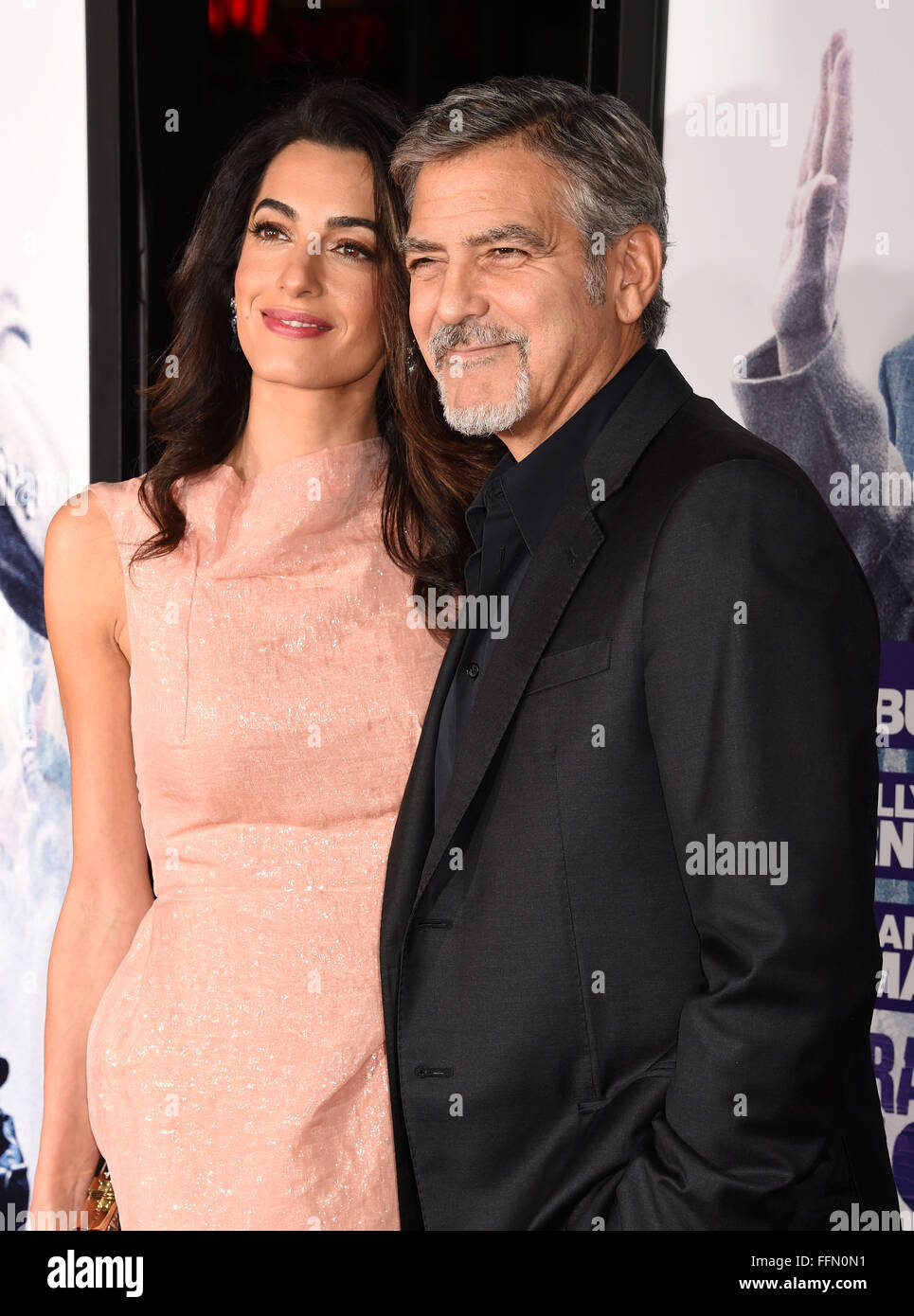 Actor George Clooney (R) and wife Amal Clooney arrive at the premiere of Warner Bros. Pictures' 'Our Brand Is Crisis' at TCL Chinese Theatre on October 26, 2015 in Hollywood, California., Stock Photo