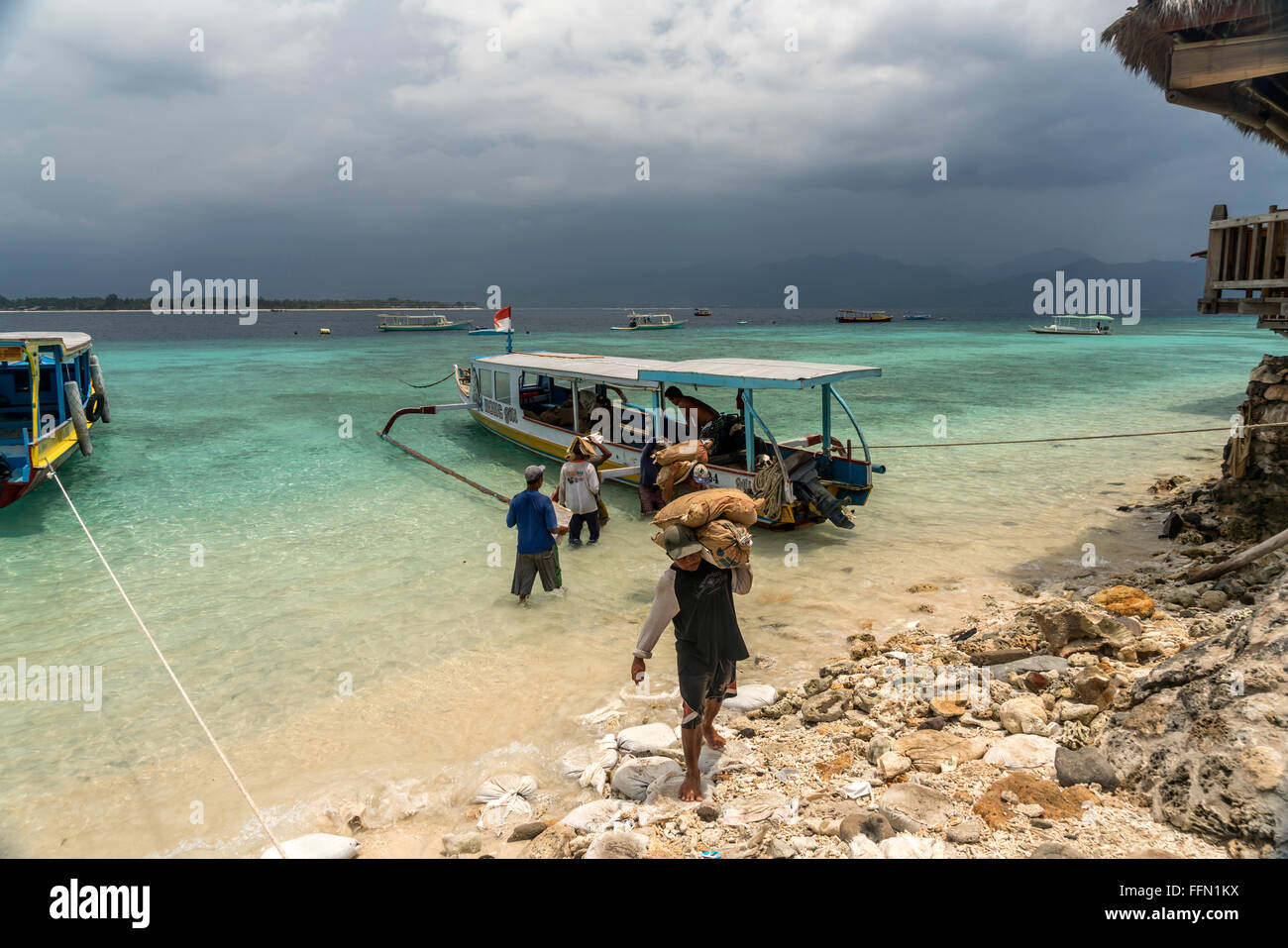 worker carrying construction materials to the small island Gili Meno, Lombok, Indonesia, Asia Stock Photo
