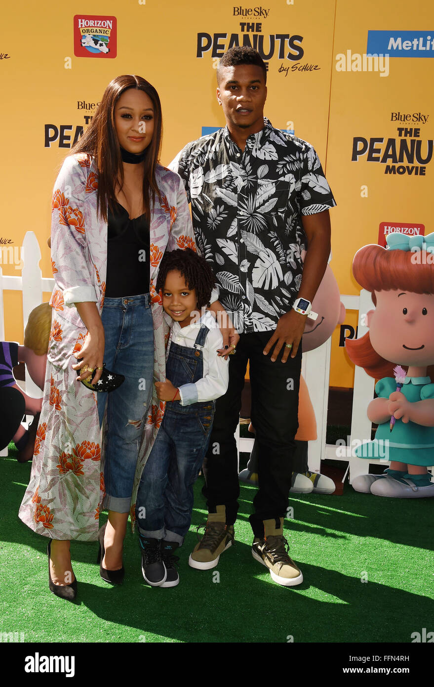 Actress Tia Mowry, son Cree Taylor Hardrict and husband Cory Hardrict attend the Premiere of 20th Century Fox's 'The Peanuts Movie' at the Regency Village Theatre on November 1, 2015 in Westwood, California., Stock Photo