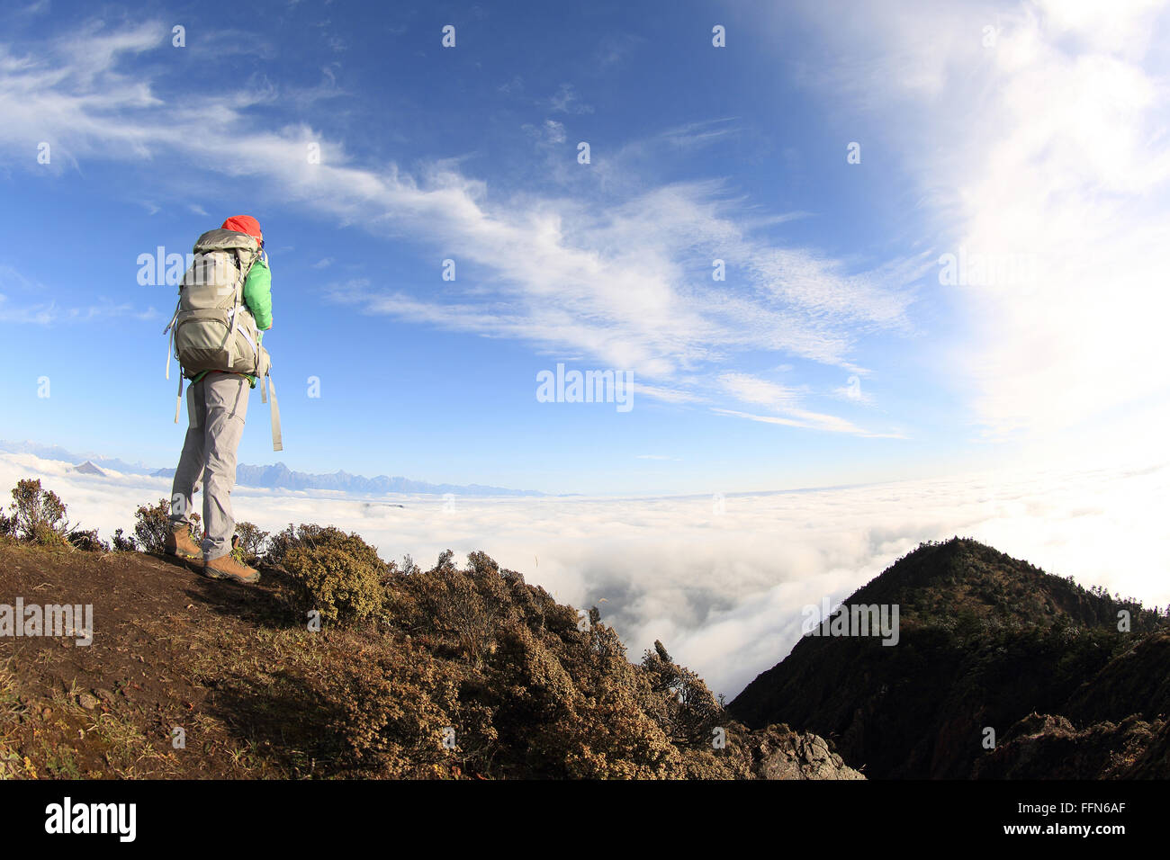 young woman backpacker hiking at mountain peak Stock Photo - Alamy