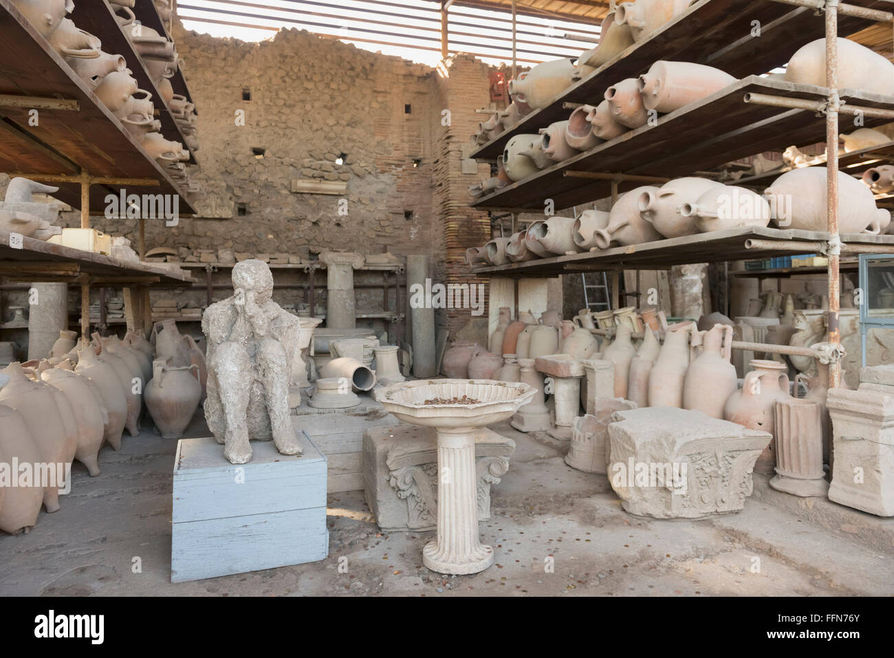 Earthenware pots and the cast of a person recovered from the ruins in Pompeii, Italy, Europe Stock Photo