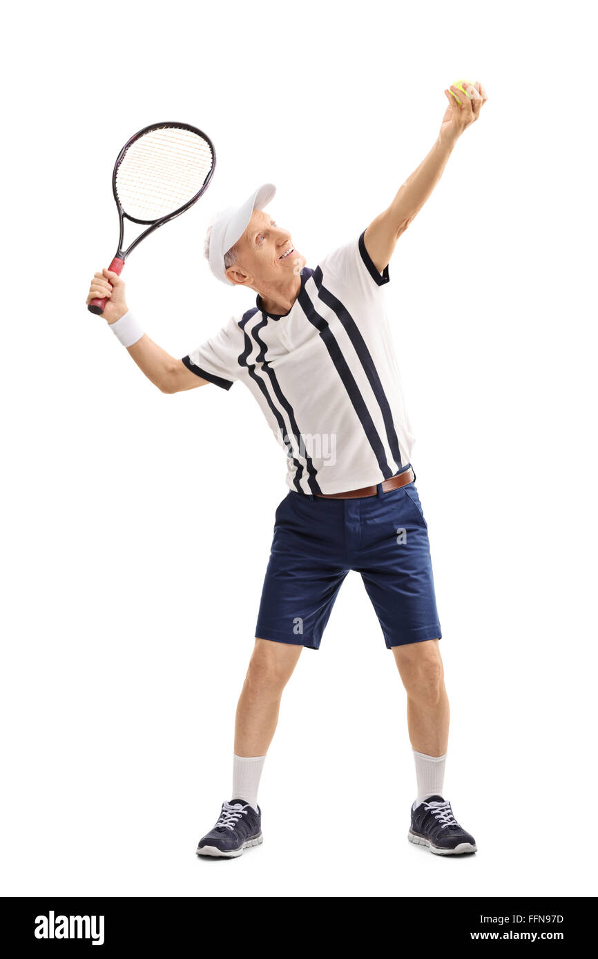 Full length profile shot of a senior tennis player preparing to serve isolated on white background Stock Photo
