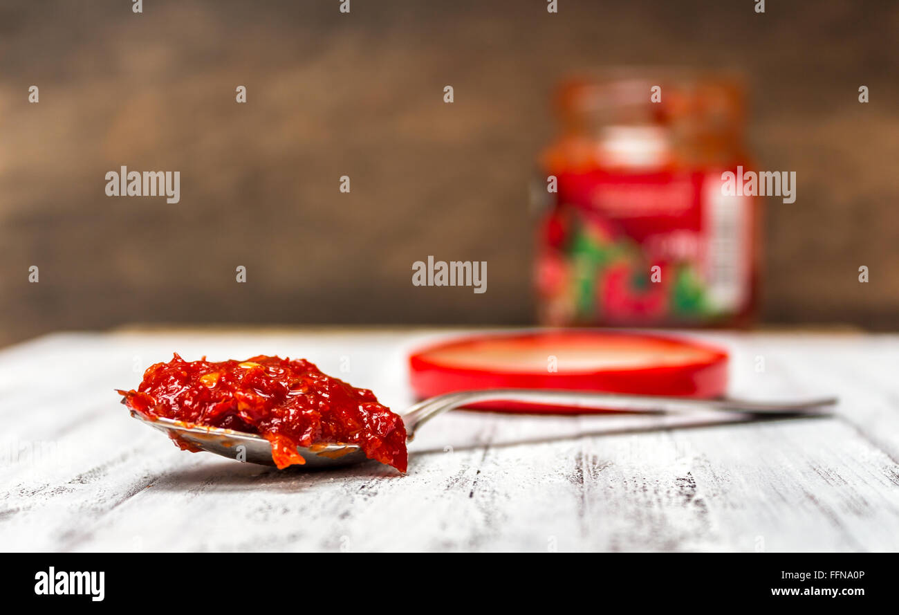 A jar and a spoonful of Hungarian hot paprika paste Stock Photo