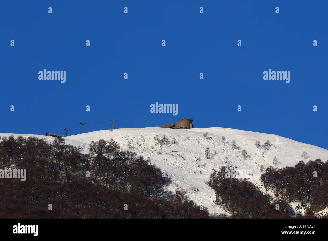 Mount Tamaro in Ticino covered in snow with clear blue skies Stock Photo