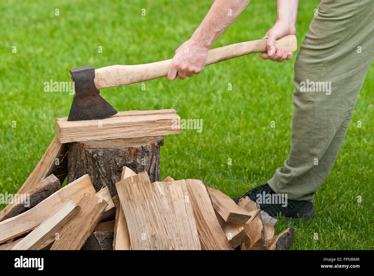 old used ax with a log in the garden Stock Photo