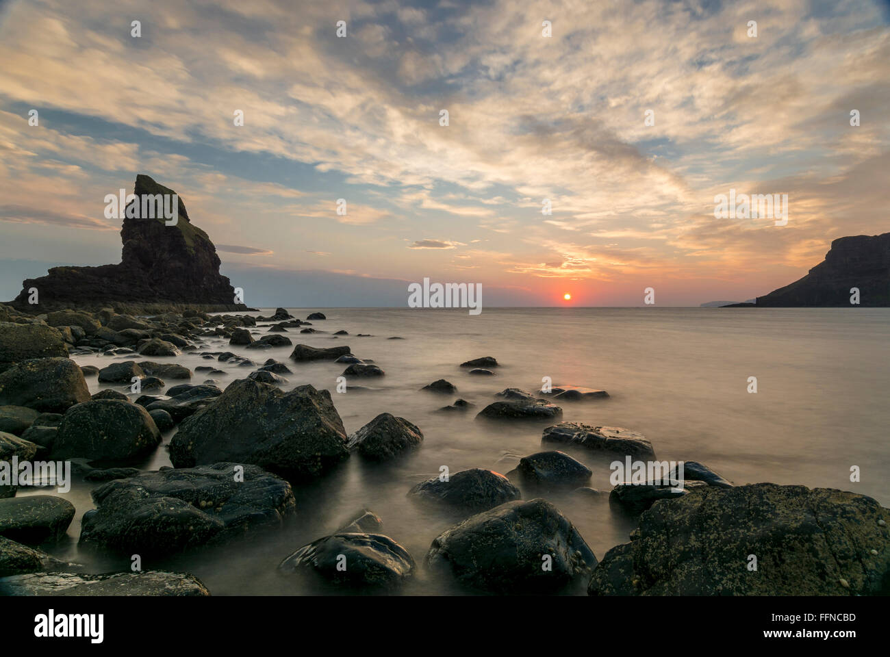 talisker bay at sunset rocks on shore at west coast Stock Photo