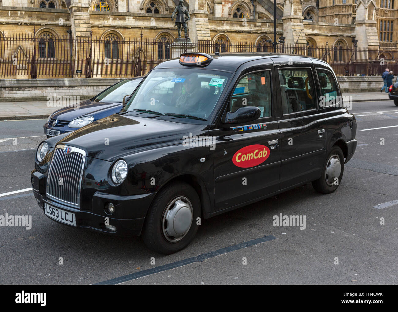 London taxi cab outside the Houses of Parliament (Palace of Westminster), Westminster, London, England, UK Stock Photo