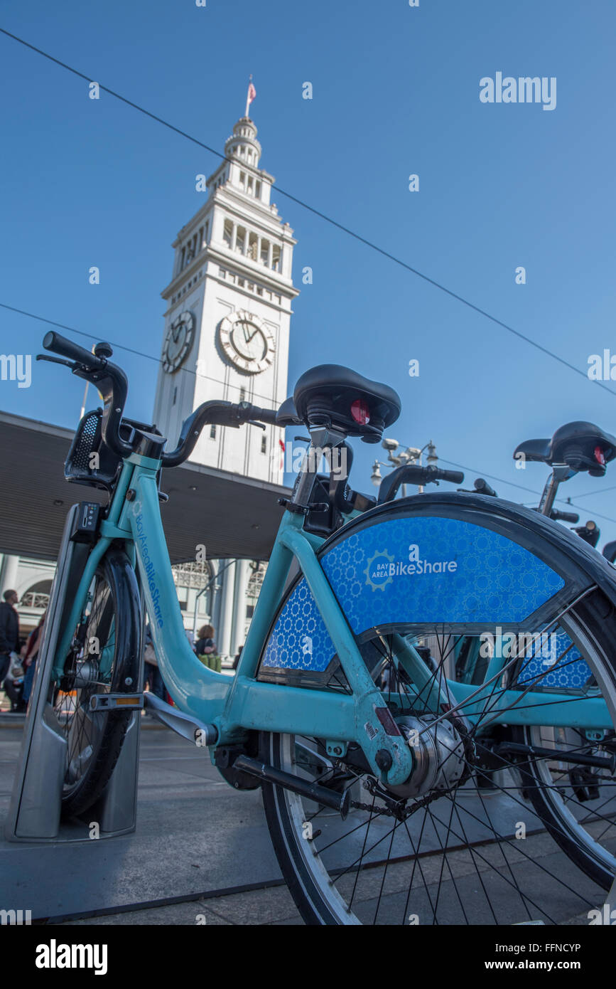Bicycle, part of the Bay Area Bike Share scheme ready to be used outside the ferry terminal building in San Francisco. USA. Stock Photo