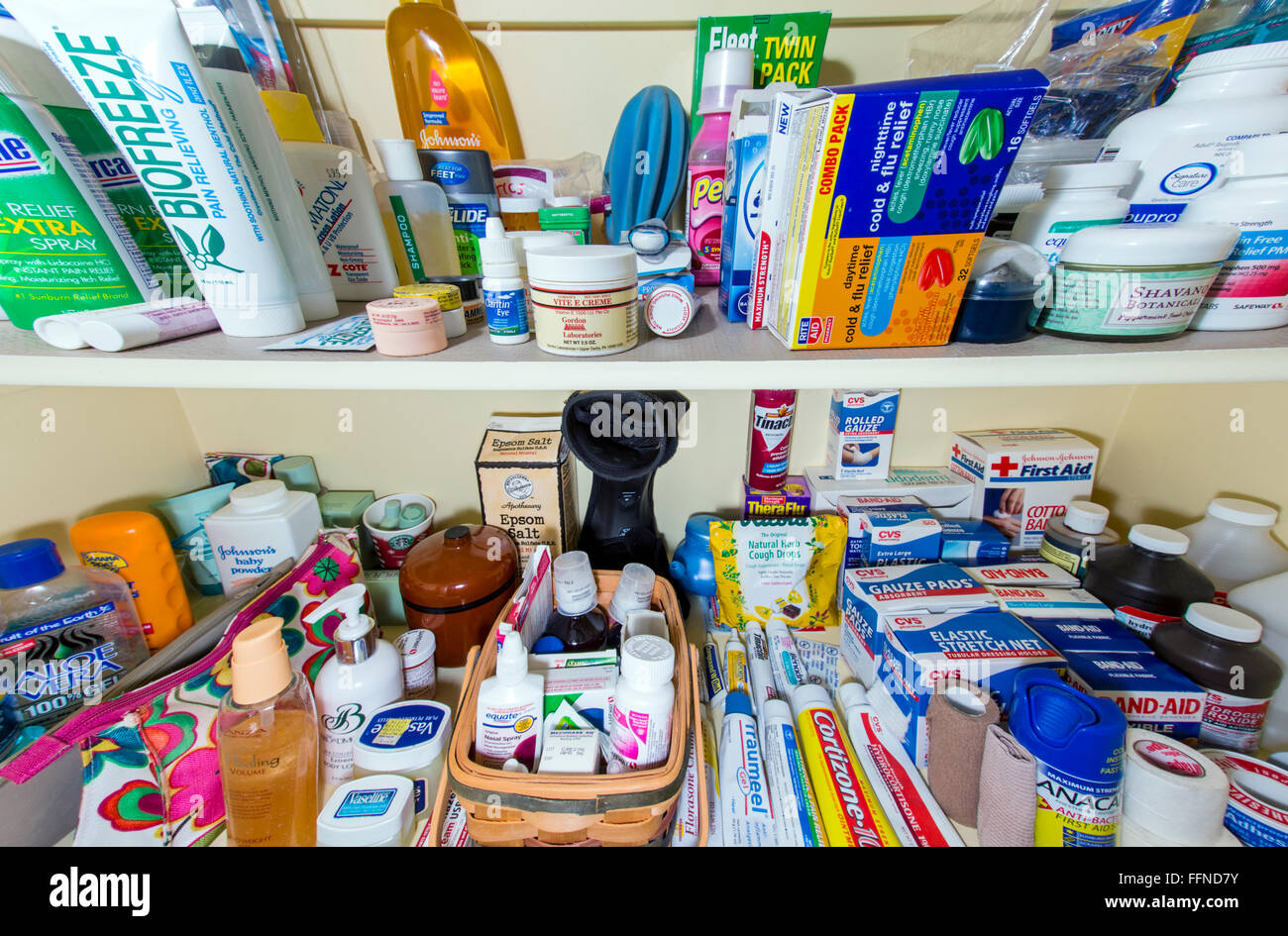 Wide angle view of home medicine cabinet shelves full of pharmaceuticals, drugs, balms, bandages, ointments and personals Stock Photo