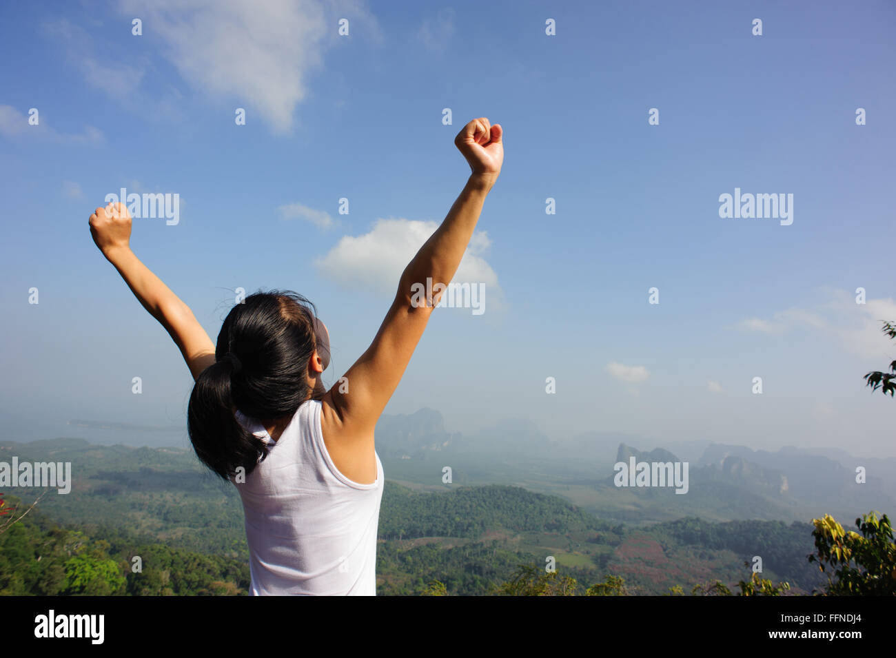 young woman cheering open arms at mountain peak Stock Photo - Alamy