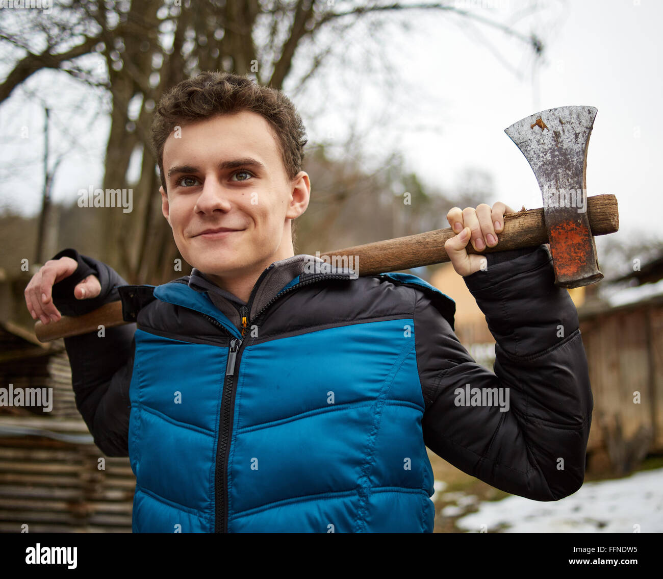 Handsome teenage country boy holding axes outdoor Stock Photo Alamy