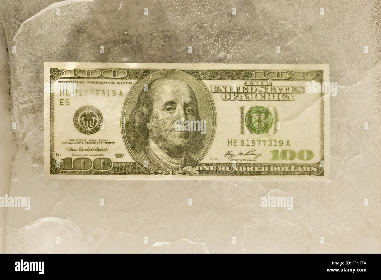 One Hundred Dollar Bill Frozen in Ice Stock Photo