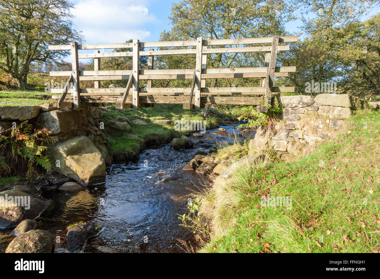 Wooden bridge over Burbage Brook on the Longshaw Estate in Derbyshire, Peak District, England, UK Stock Photo