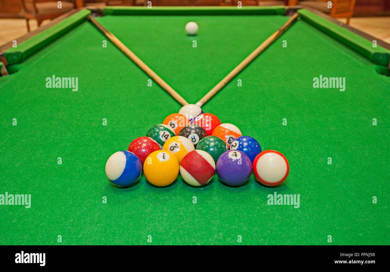 Closeup detail of a pool billiards tables with balls and cues Stock Photo