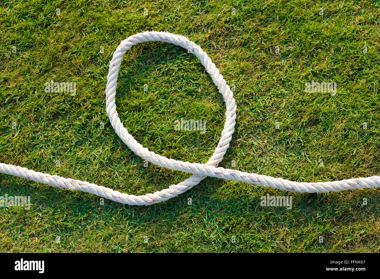 circle white rope on green grass lawn Stock Photo