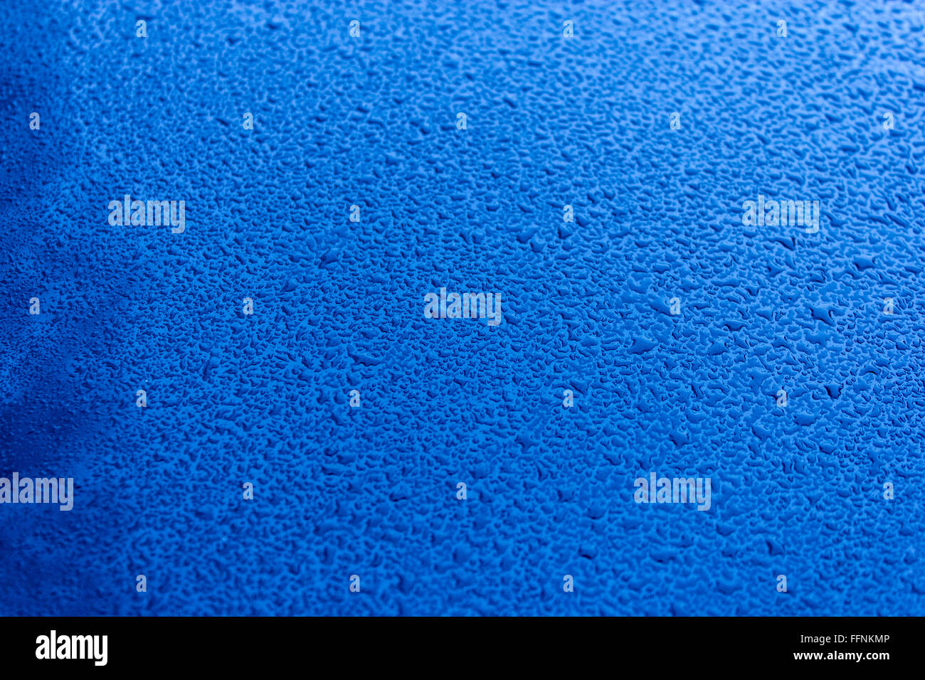 Waterdrops on blue car paint as underground, shallow focus Stock Photo