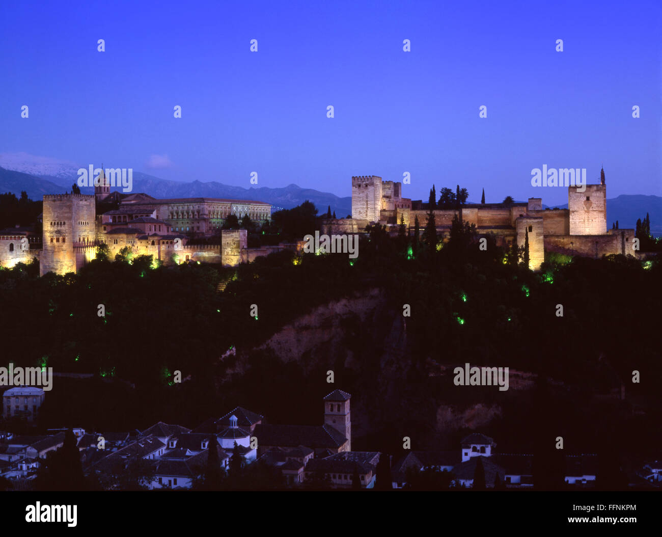 Alhambra Palace and Sierra Nevada mountains at night dusk twilight from Mirador San Nicolas Granada Andalucia Spain Stock Photo