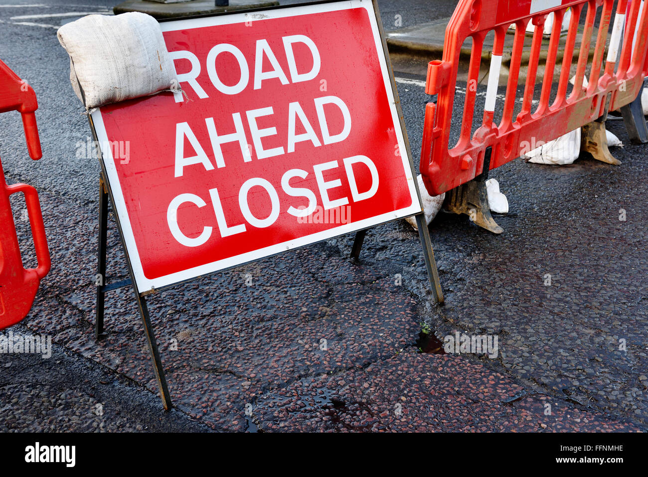 Sign road ahead closed and barrier across road Stock Photo Alamy