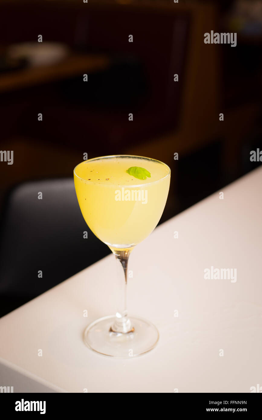 Gin based cocktail with yellow chartreuse and a basil and black pepper