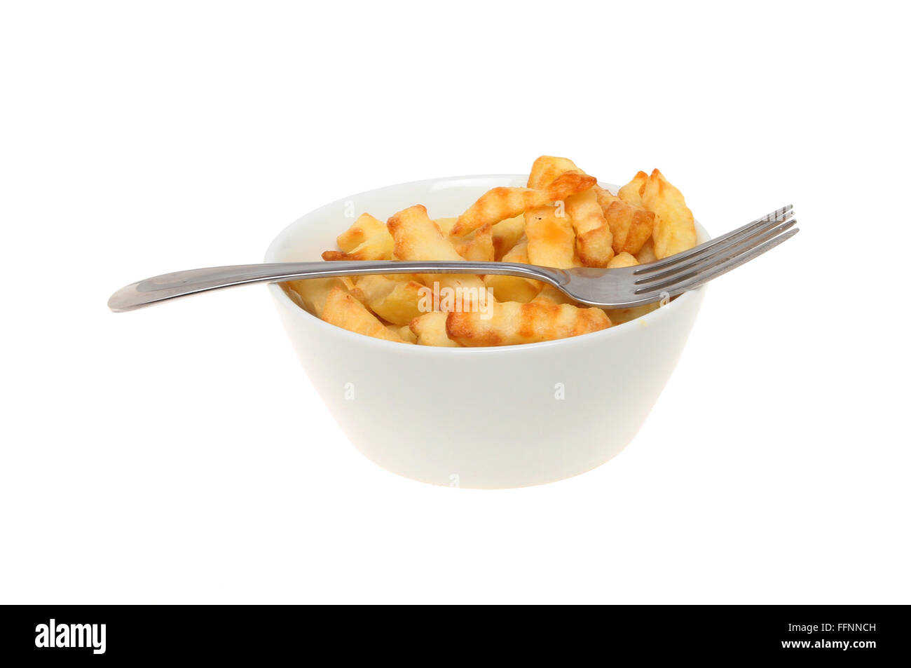 Bowl of crinkle cut chips with a fork isolated against white Stock Photo