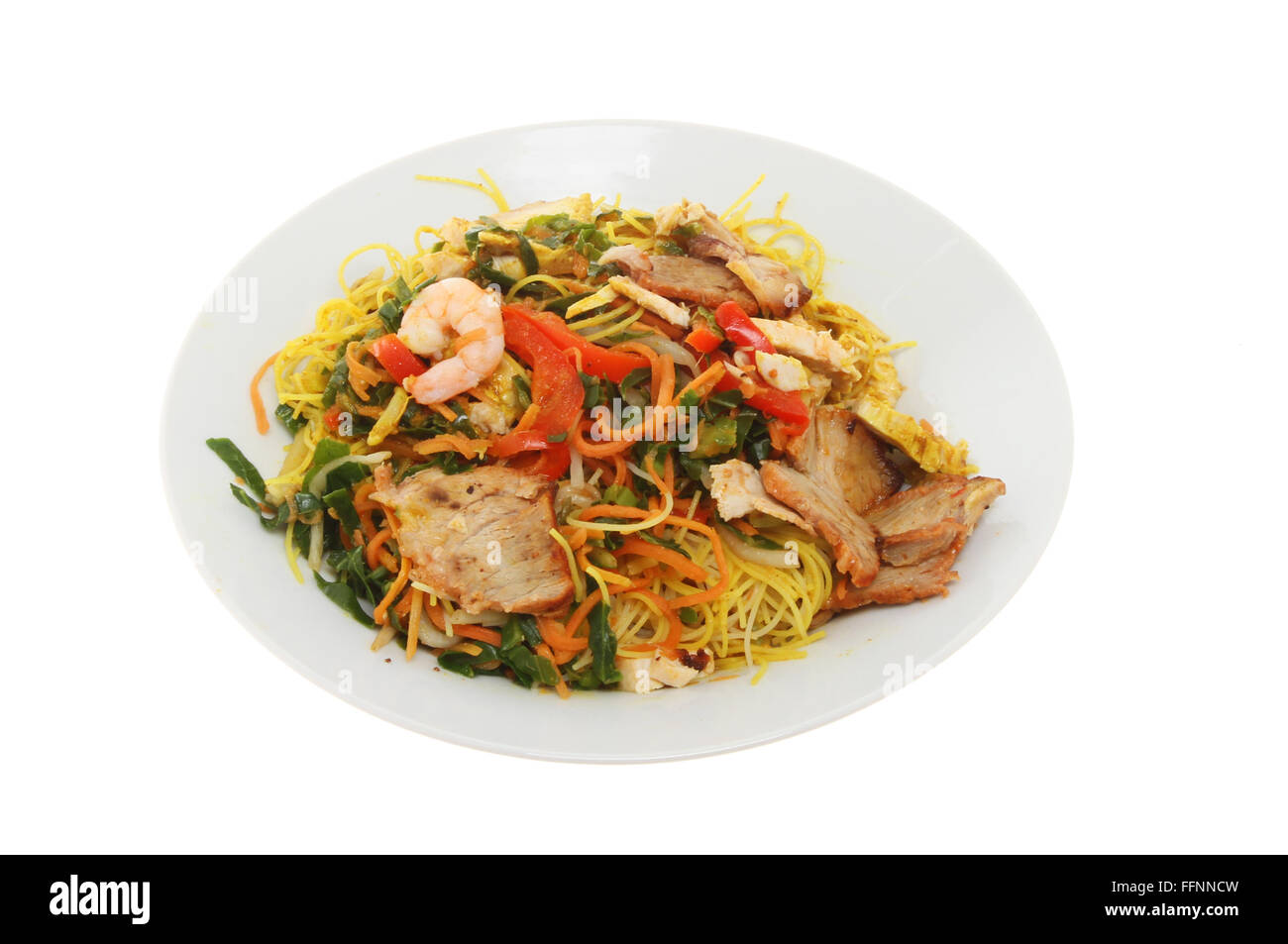 Chinese meal, Singapore noodles in a bowl isolated against white Stock Photo