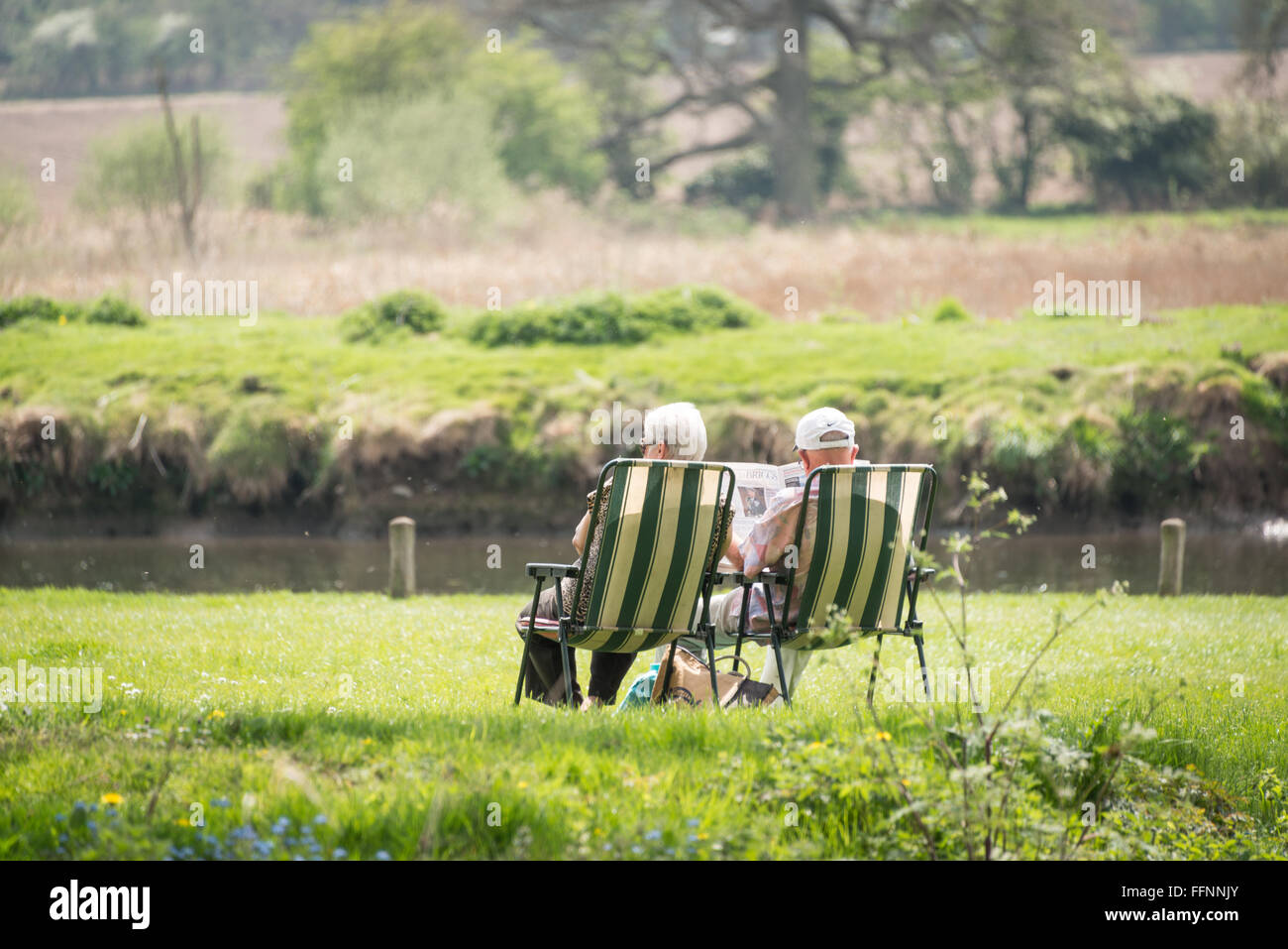 Sitting by the river Bure at Coltishall, Norfolk Stock Photo