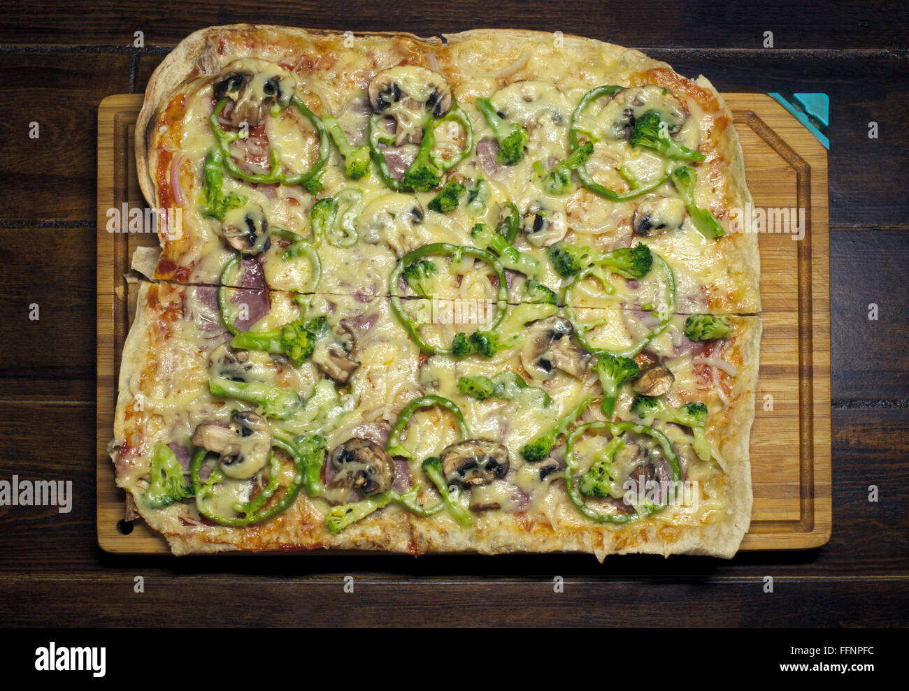 Square homemade pizza on the wooden plate over wooden table Stock Photo