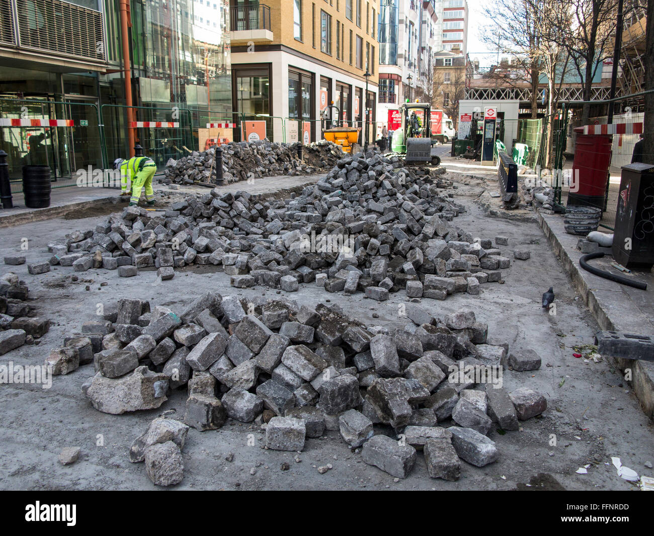 Laying cobbles and stones on a road in Soho, central London Stock Photo