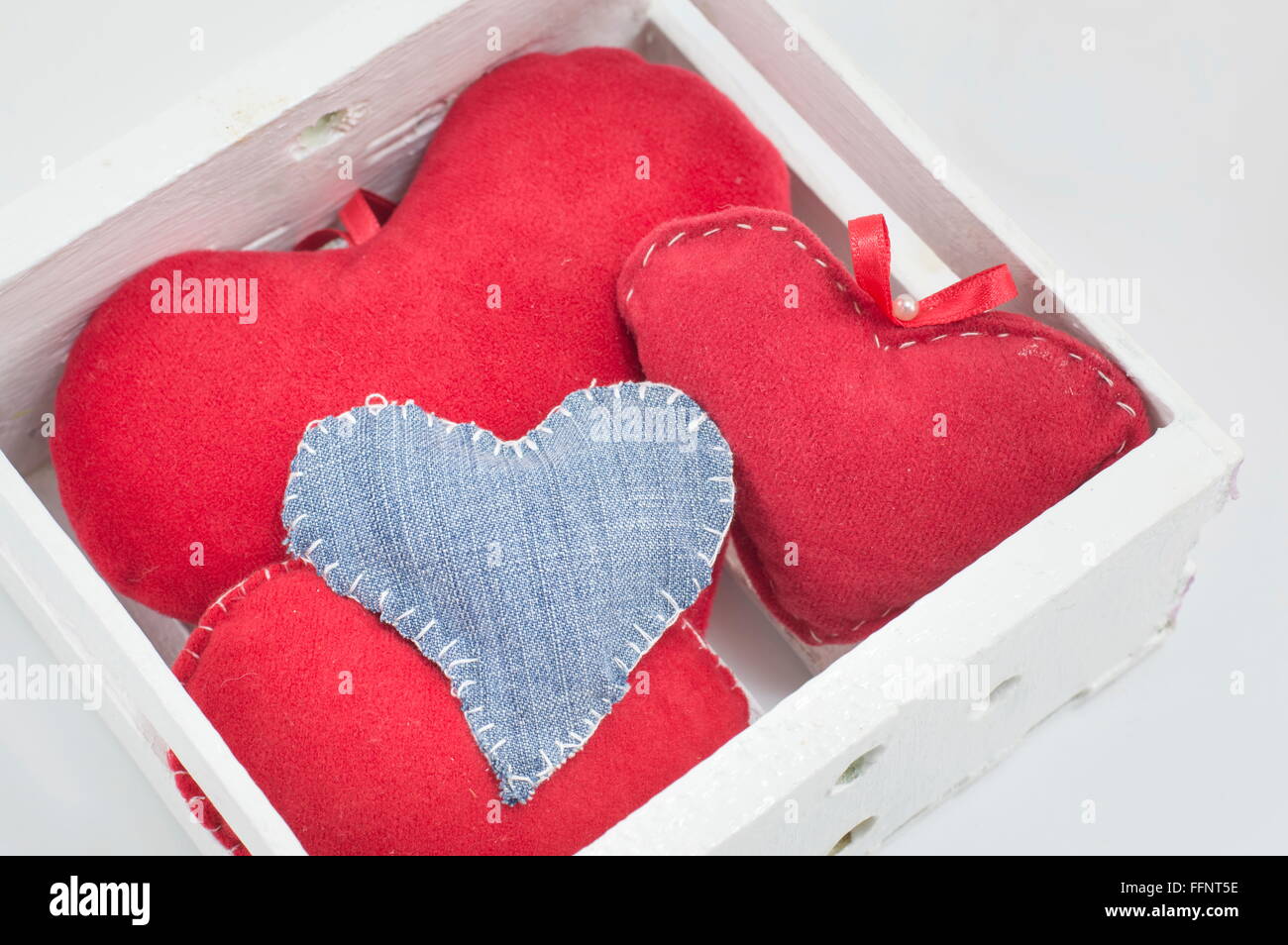 box full of red and denim hearts Stock Photo