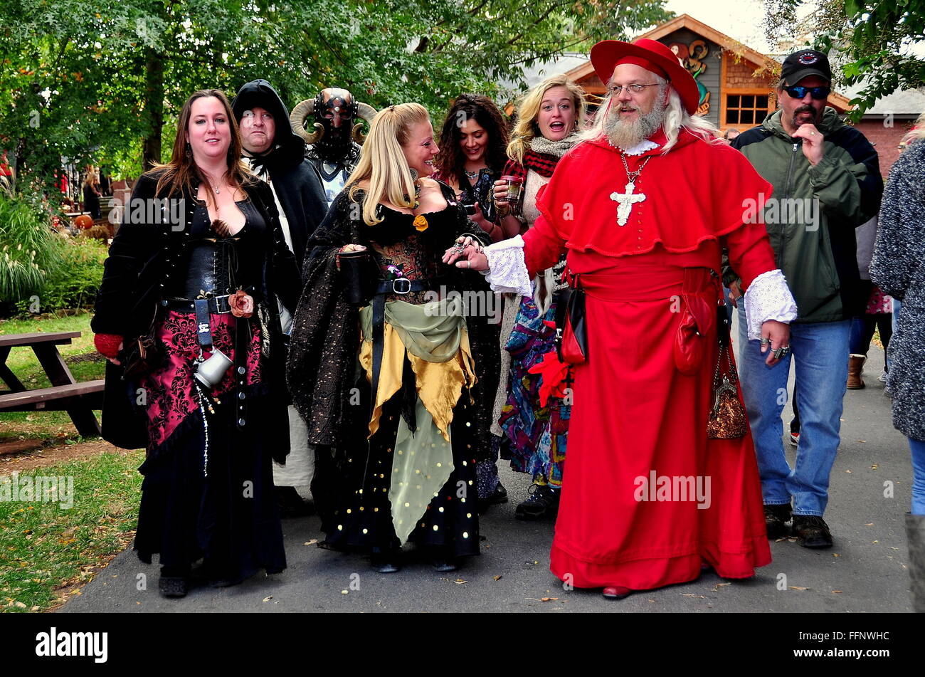 Mount Hope, Pennsylvania:  Merrymakers in splendid medieval clothing accompany a Cardinal at PA Renaissance Faire Stock Photo