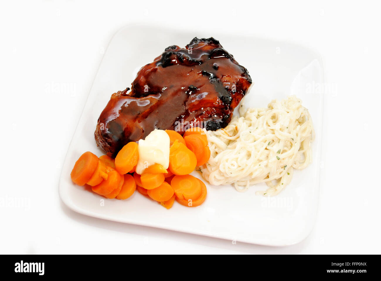Delicious Summer Meal of Pork Rib, Carrots and Pasta Stock Photo