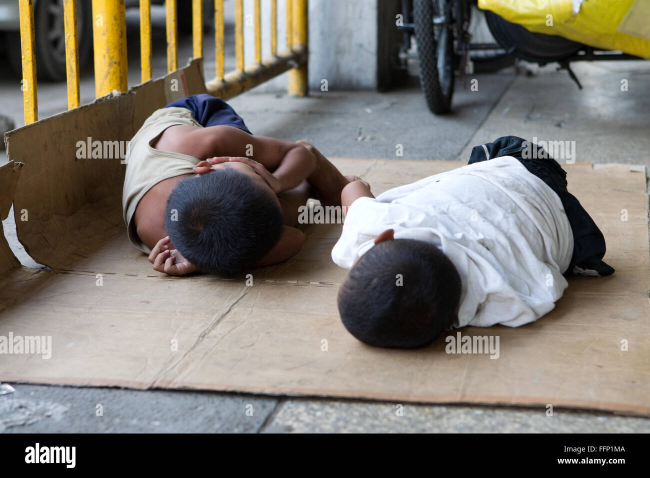 Within Philippine Cities homeless people,which include children & entire families can be seen sleeping on sidewalks. Stock Photo