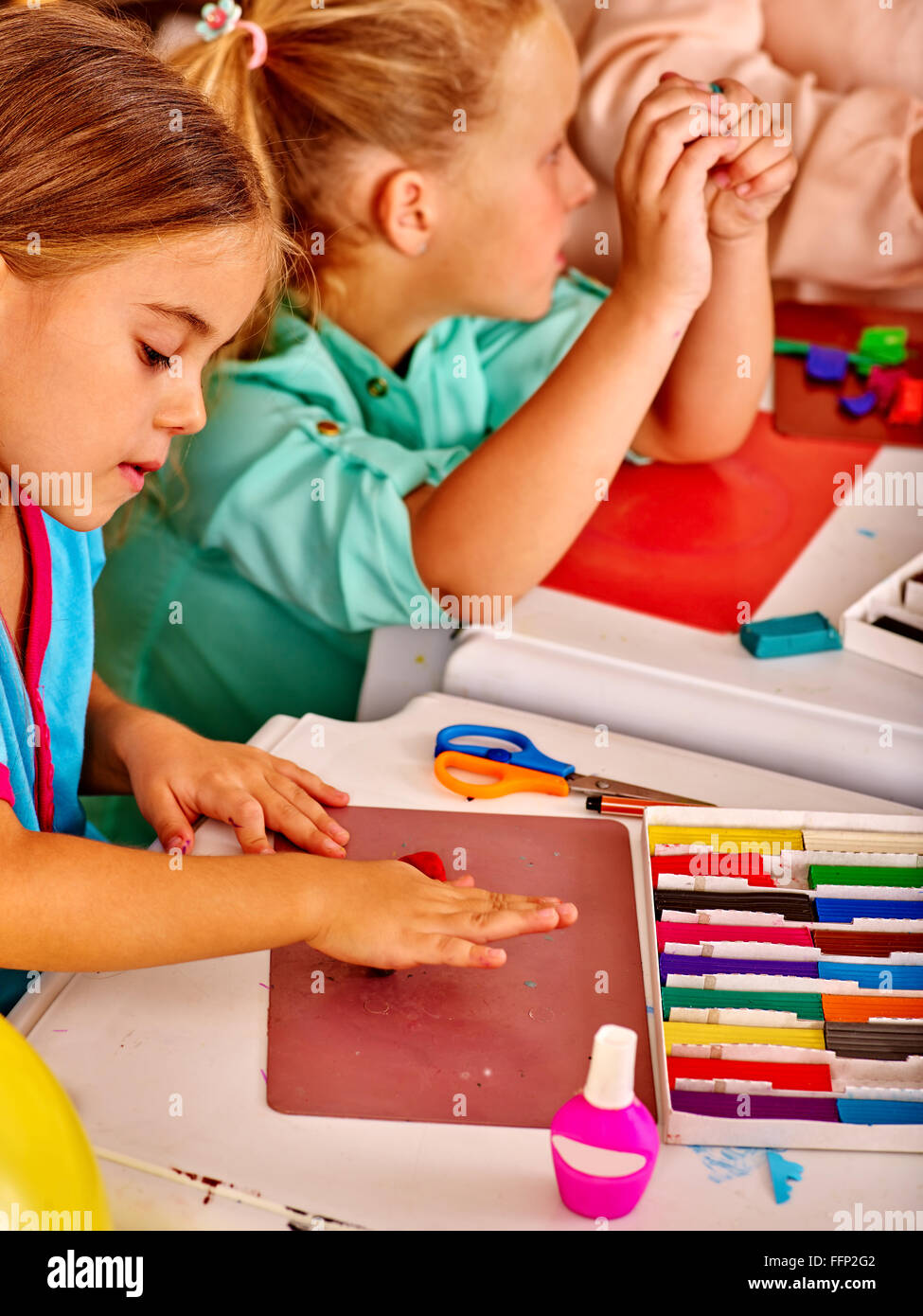 Plasticine modeling clay in children class. Teacher teaches kids together  play dough and mold from plasticine in kindergarten or preschool.  Developmen Stock Photo - Alamy