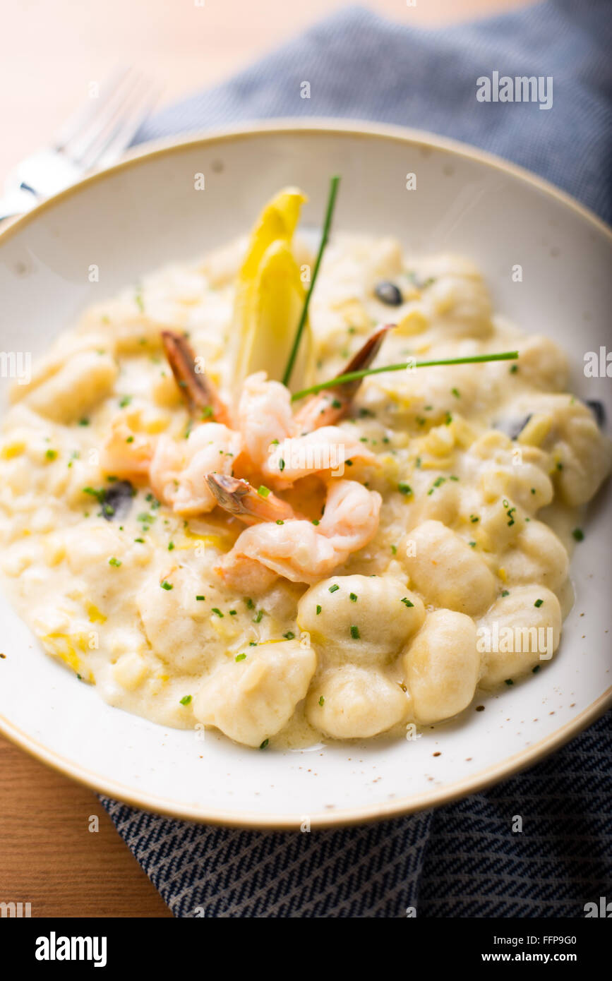 Gnocchi in a truffle cream sauce with shrimp and endives Stock Photo