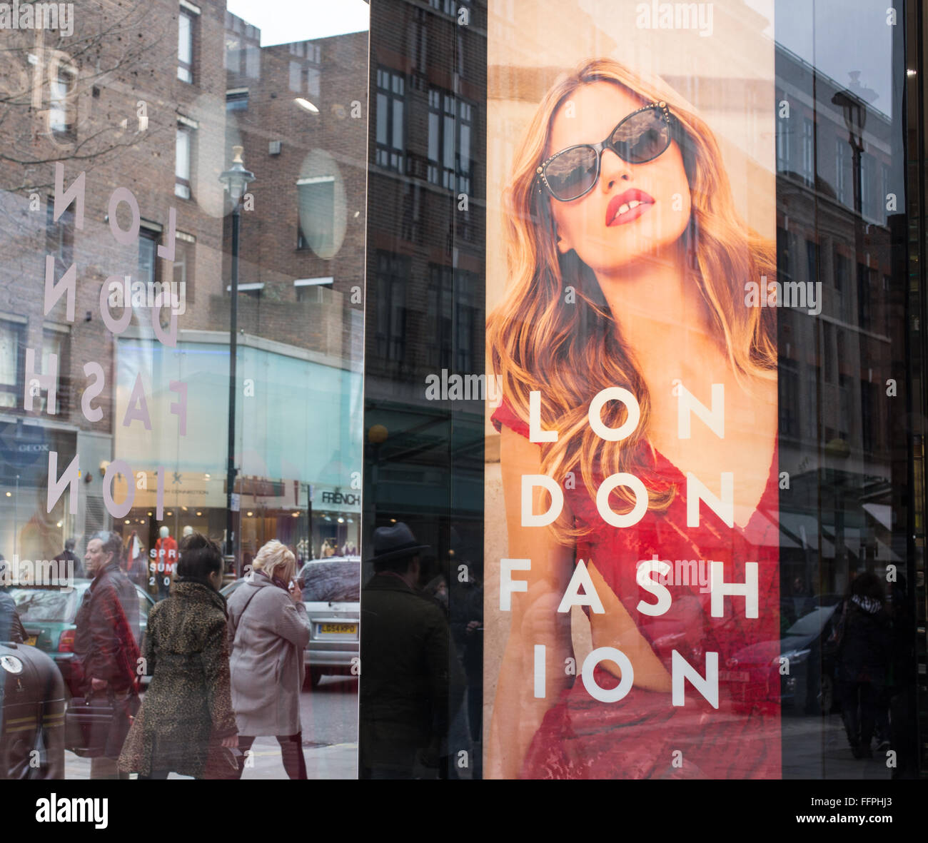 Billboard on a shop window celebrating London Fashion. It refers to the London Fashion Week that is held in London twice a year Stock Photo