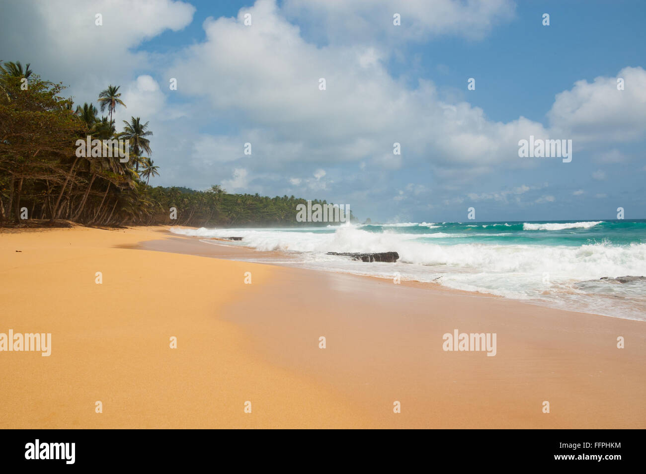 Tropical beach with palm trees and heavy sea. Praia Jale, Sao tome and Principe. Stock Photo