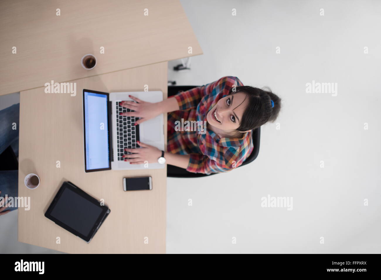 top view of young business woman working on laptop computer in modern ...