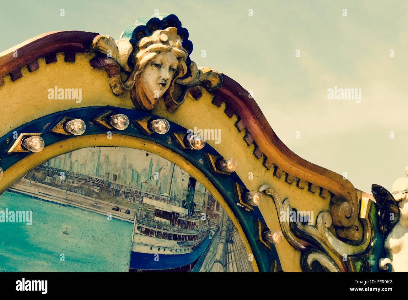 Carving of female head on old carousel Stock Photo