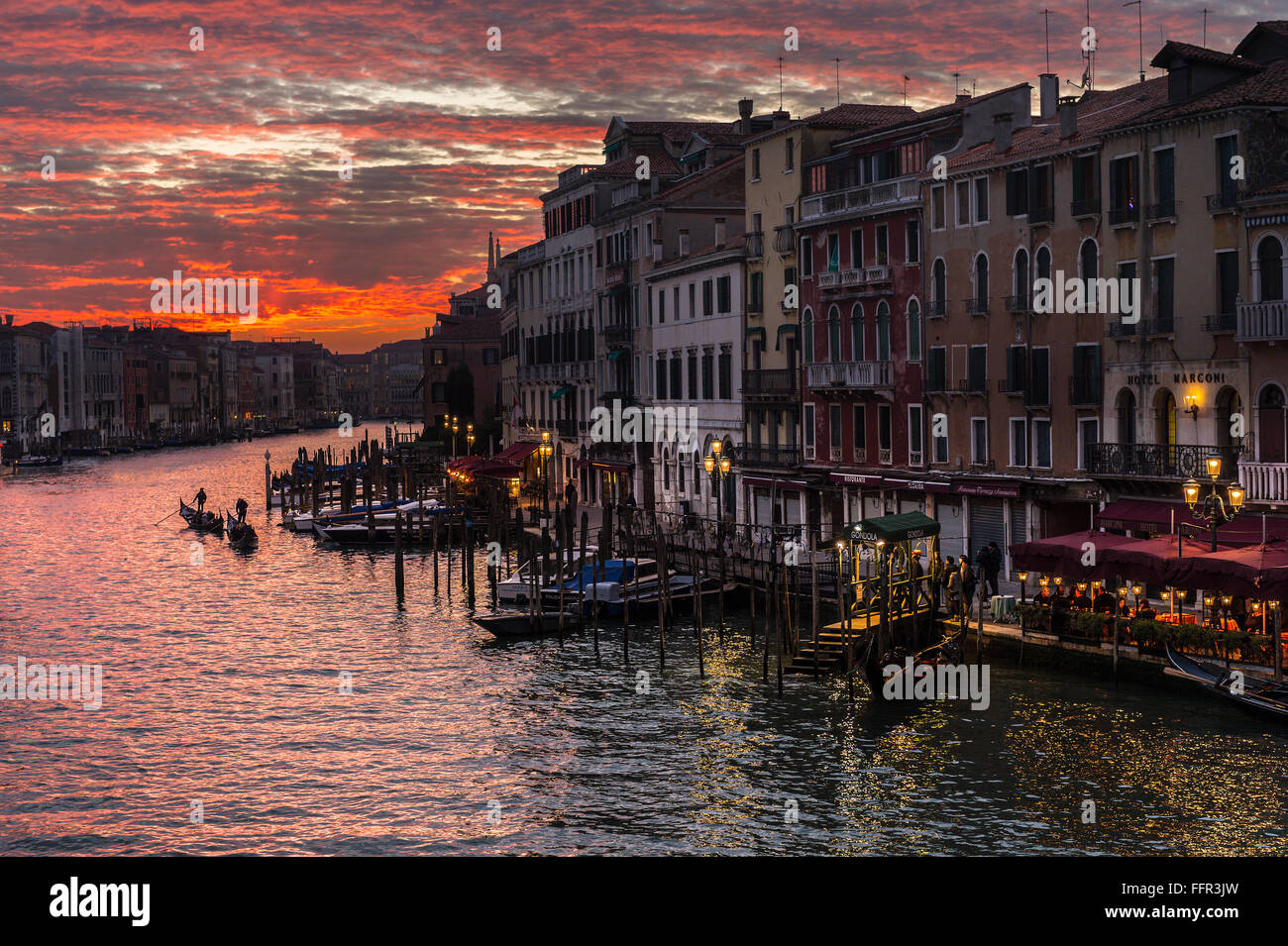 Houses and gondolas on Grand Canal at sunset, Venice, Veneto, Italy Stock Photo