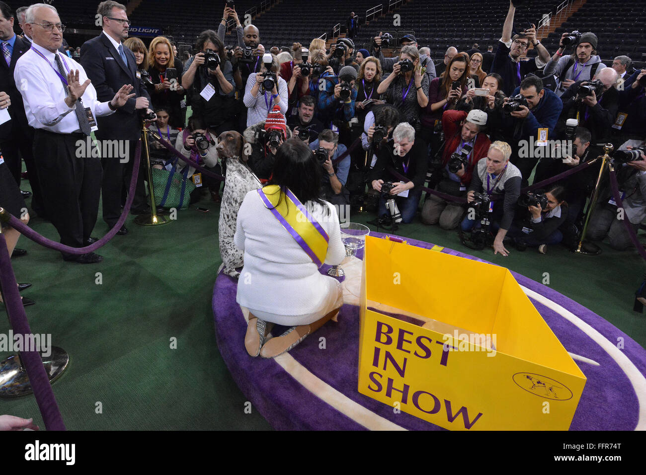 New York, USA. 16th February, 2016. C.J., a German shorthaired pointer, turns away from photographers after winning  Best in Show  at the 140th Westminster Kennel Club dog show Tuesday, Feb. 16, 2016 in New York. At right is owner-handler  Valerie Nunes-Atkinson. Credit:  Shoun Hill/Alamy Live News Stock Photo