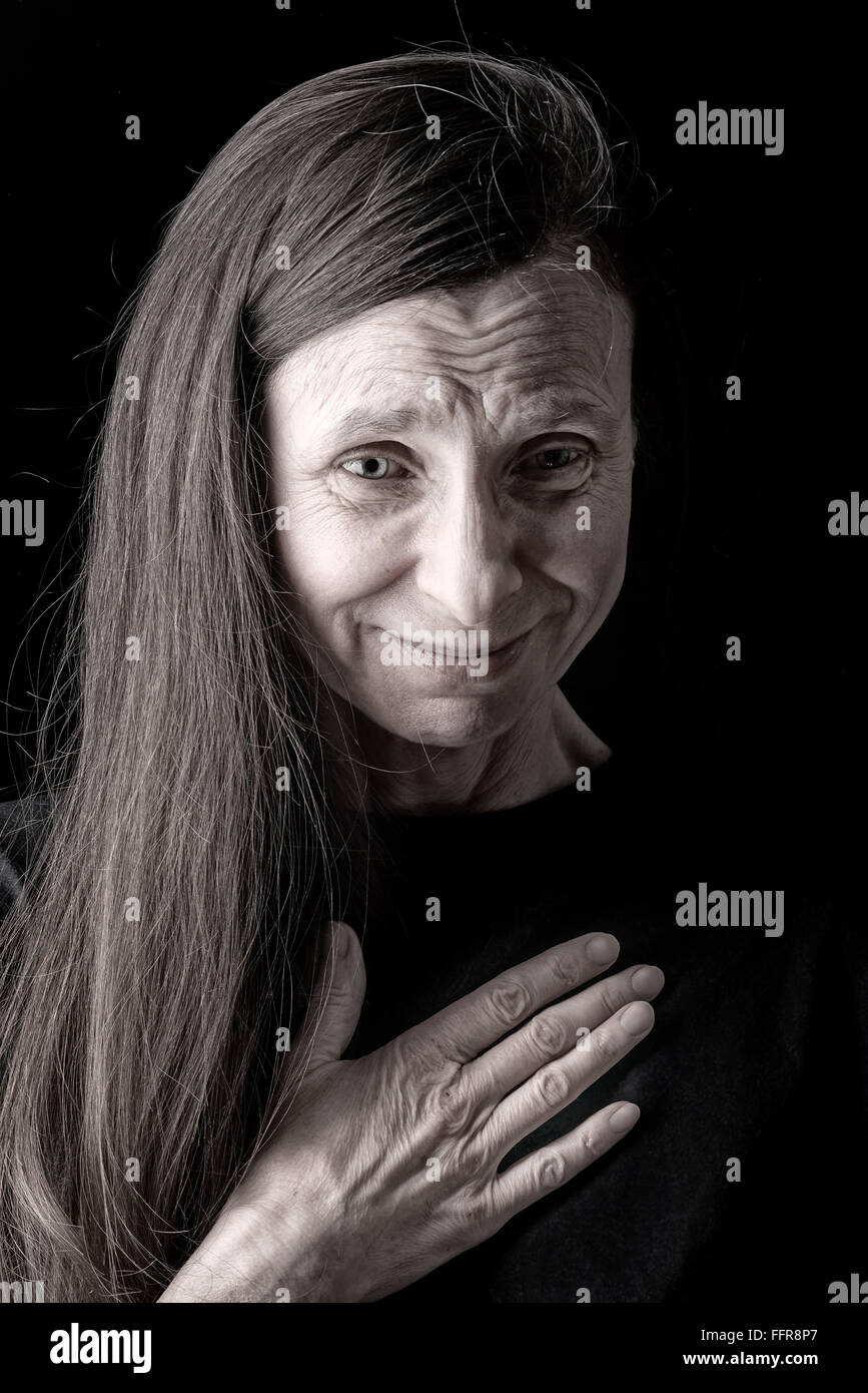 An adult woman with long hair has nausea and put the right hand on her chest Stock Photo