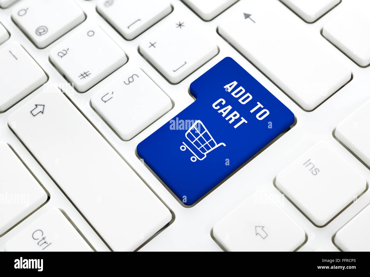 Shop on line add to cart business concept, Blue shopping cart button or key on white keyboard photography. Stock Photo