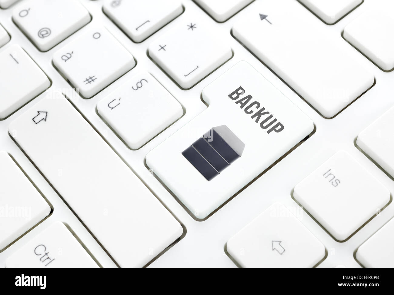 Backup safety storage technology concept. Hard disk button or key on white keyboard Stock Photo