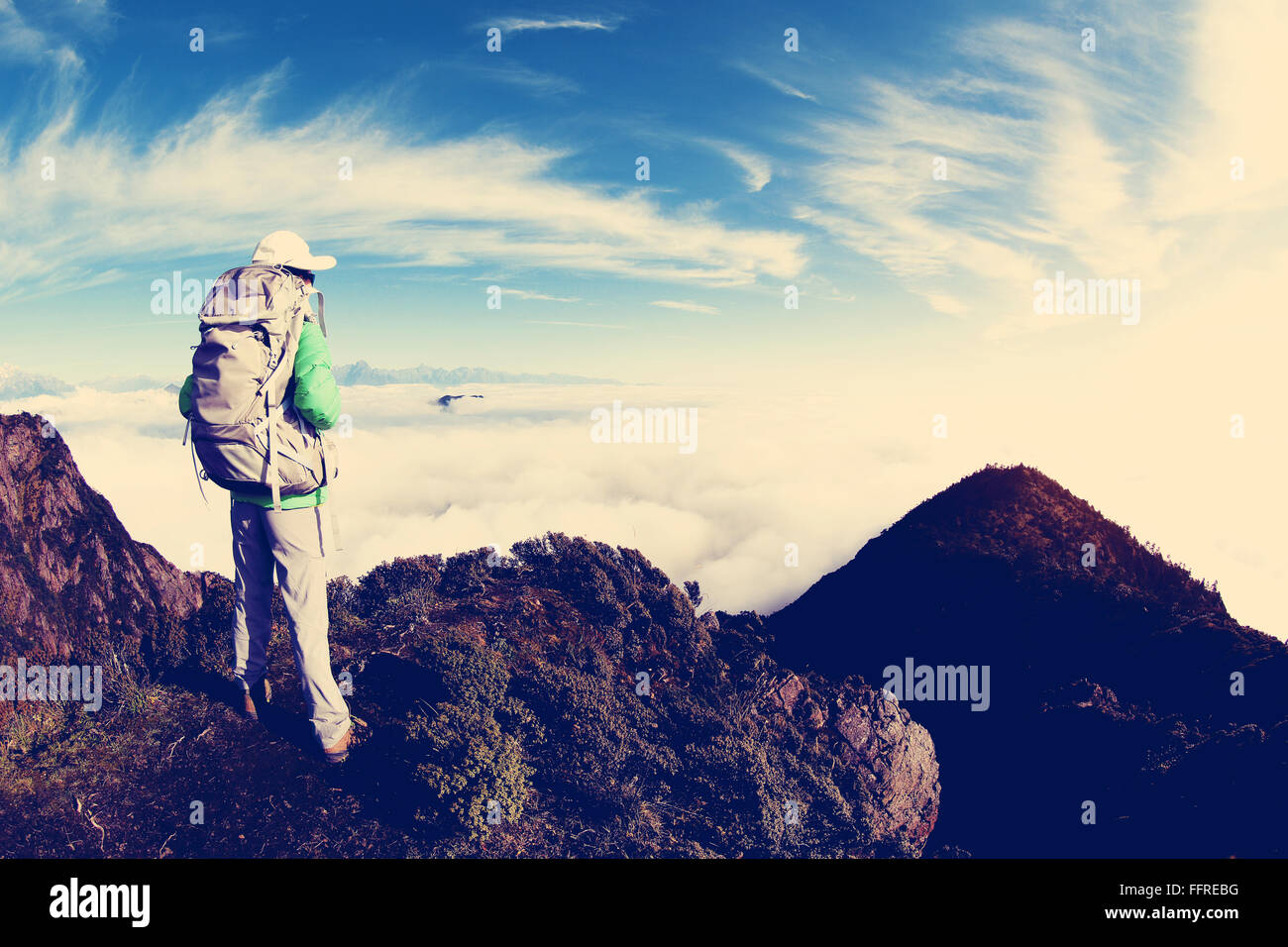 young woman backpacker hiking at mountain peak Stock Photo - Alamy