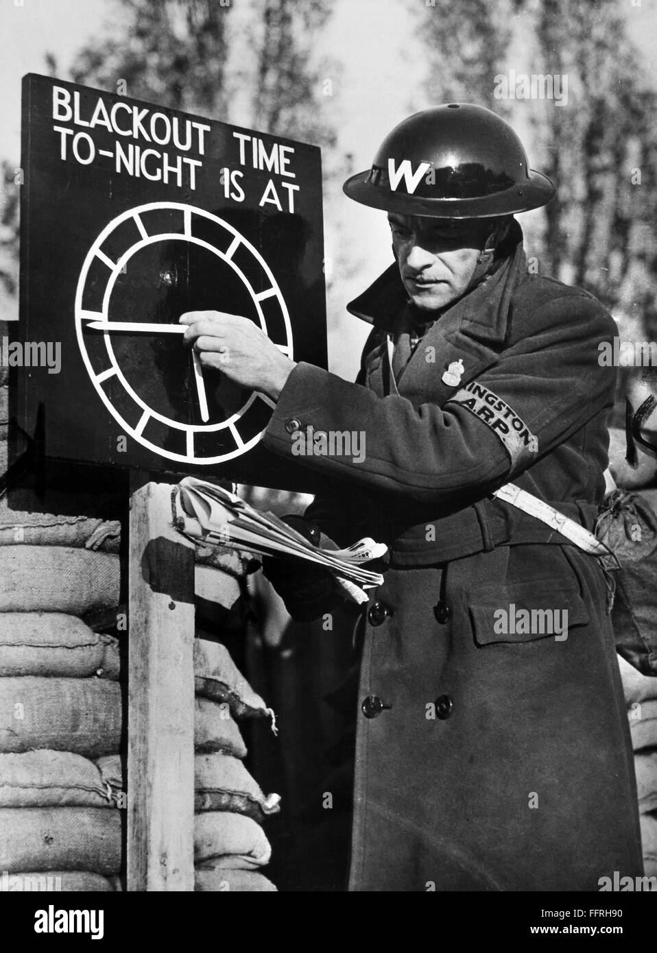 WORLD WAR II: AIR RAIDS. /nAn air raid warden setting a blackout time ...