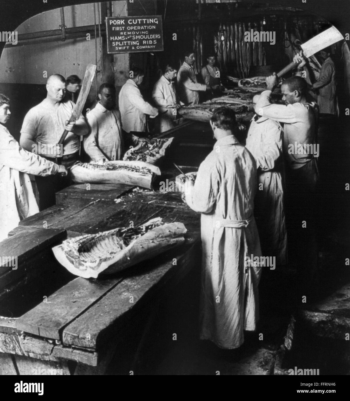 CHICAGO MEATPACKING. /nWorkers cutting up hogs by hand and removing